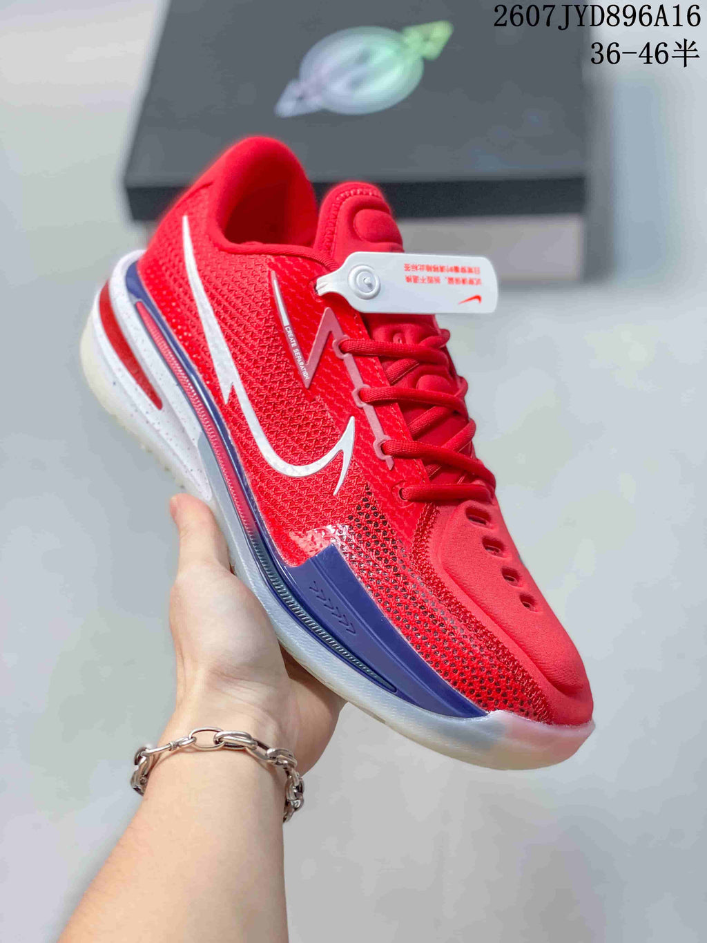Angled side view of the red basketball shoe showing the textured upper, white side branding and blue midsole accent.