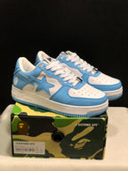 Blue and white BAPE STA low-top sneakers displayed on a camouflage shoebox; the box label shows US 7, EUR 40, and CM 25.