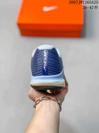 Rear view of a navy Nike Vapor 12 shoe showing the padded collar, heel branding, and layered midsole.