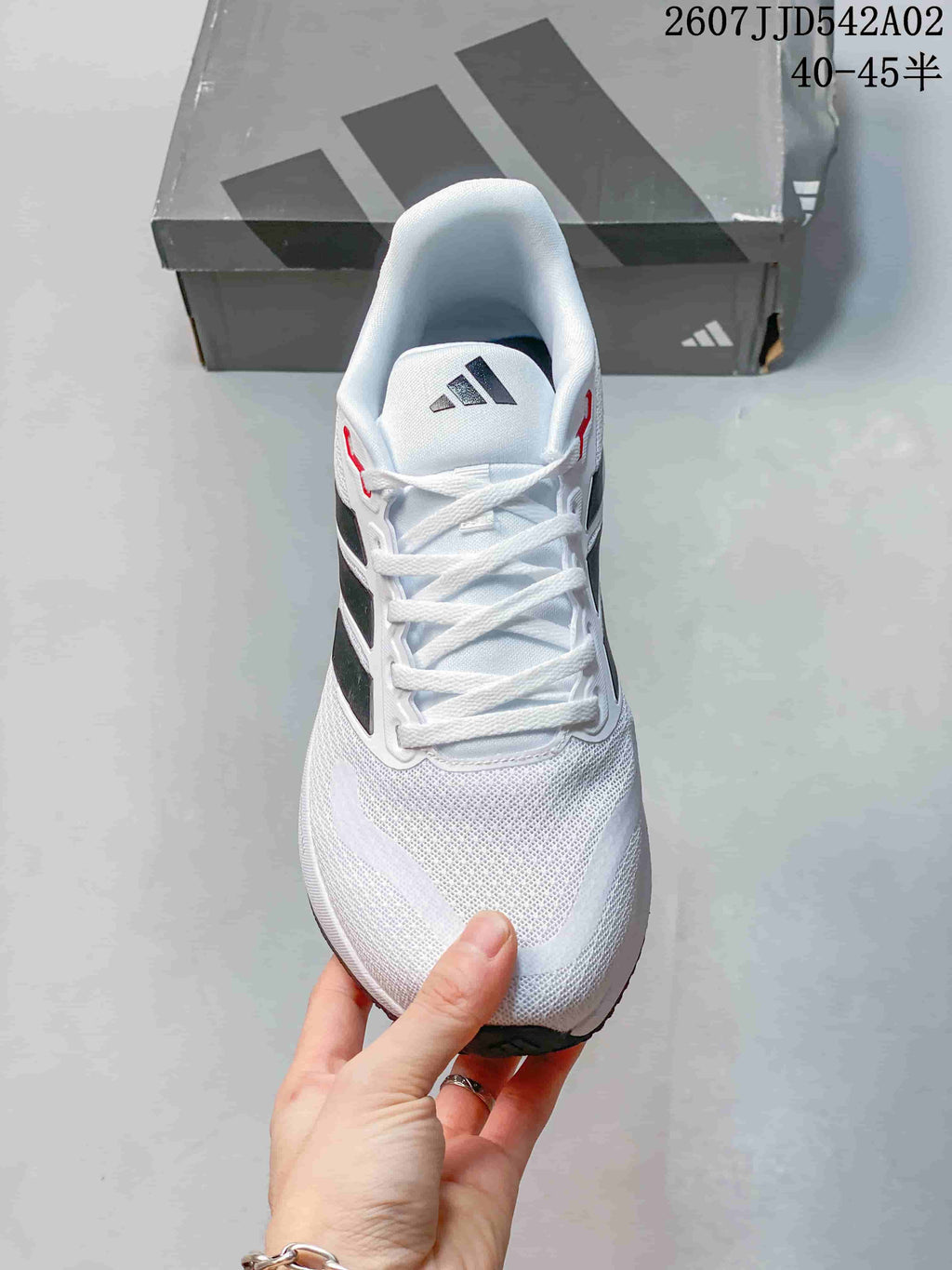 Top view of the lace-up Adidas Runfalcon 5 with a white upper and black stripes.