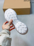 Underside view showing the white outsole with a directional tread pattern and central Salomon branding.