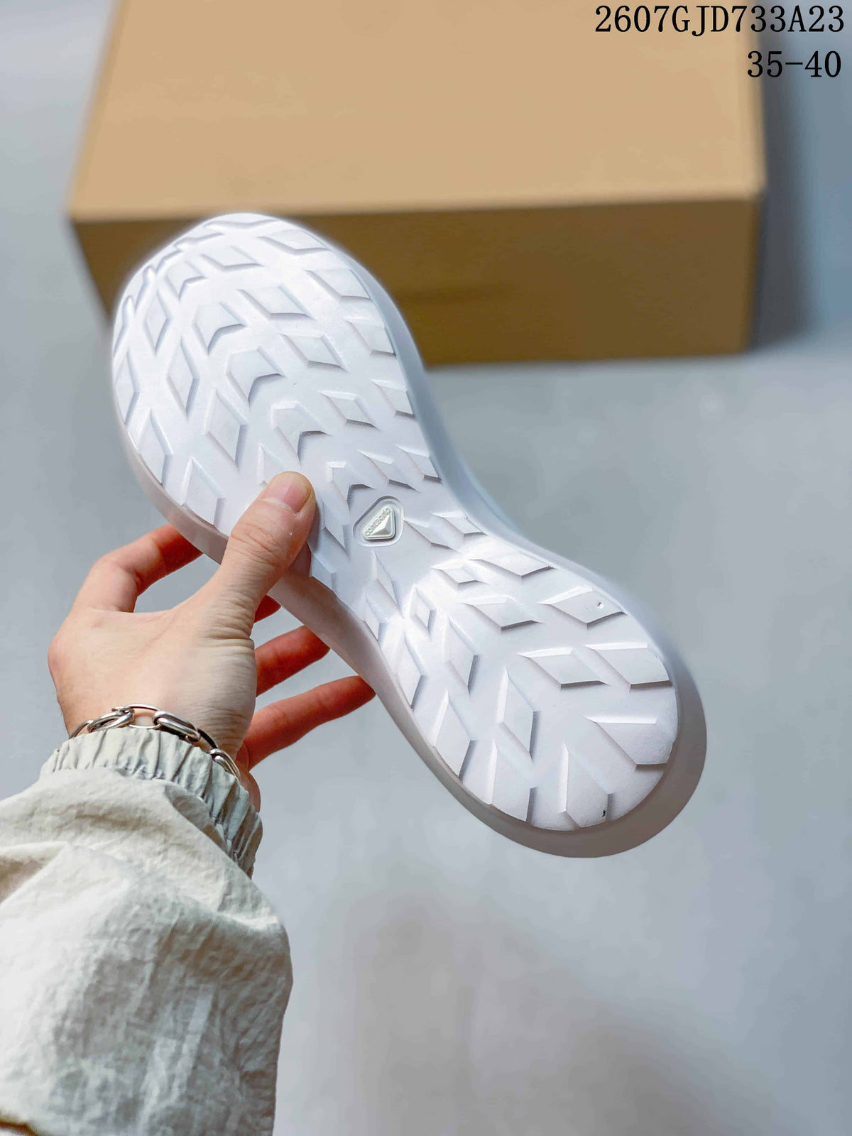 Underside view showing the white outsole with a directional tread pattern and central Salomon branding.