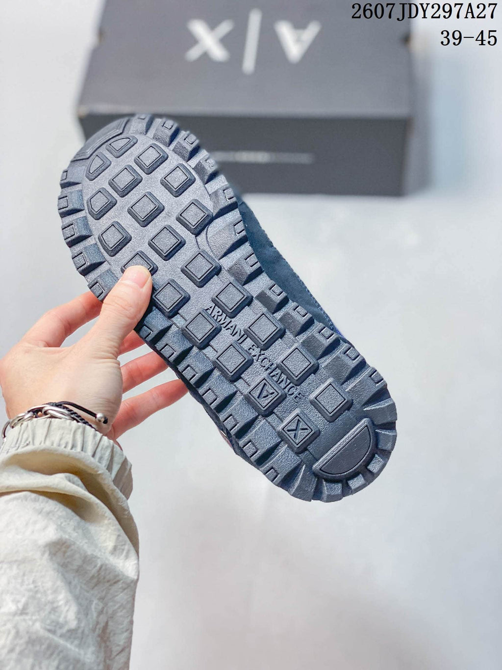 Close-up of the dark lugged outsole with Armani Exchange branding.