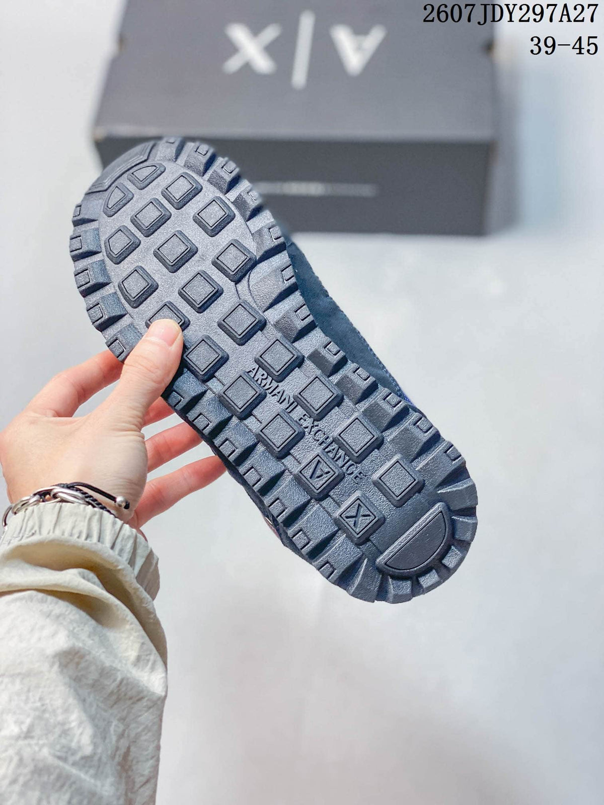 Close-up of the dark lugged outsole with Armani Exchange branding.