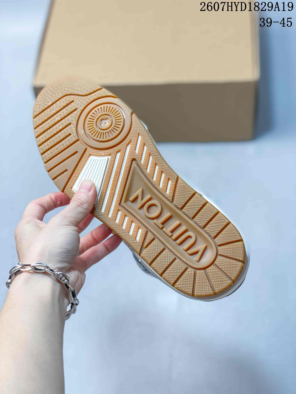Close-up of the gum-colored rubber outsole showing circular and linear traction patterns and raised branding.