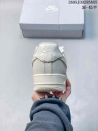 Rear view of a cream sneaker showing the Nike Air heel tab and layered heel construction.