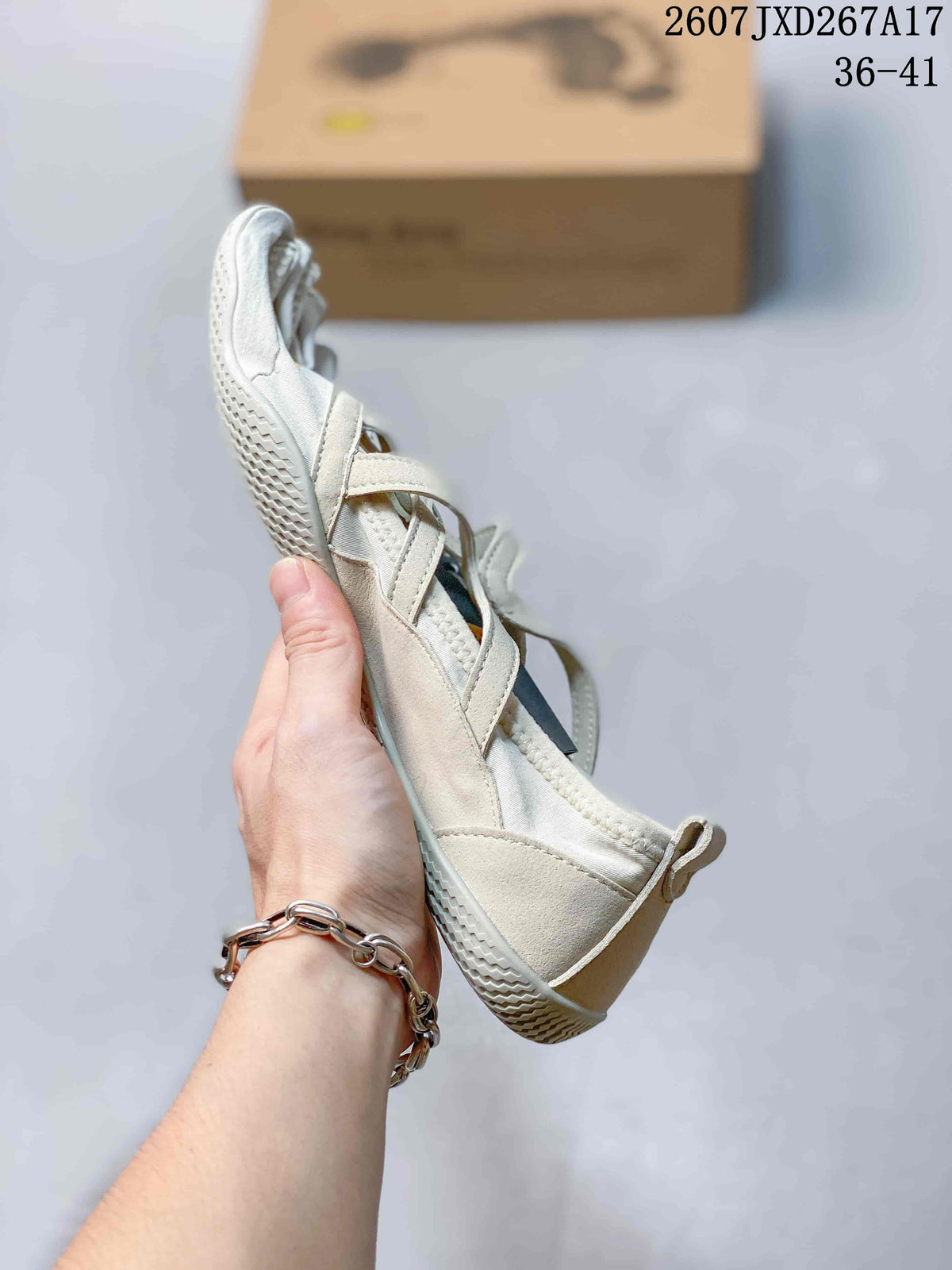 Side view of an off-white five-finger training shoe showing the low-top profile, straps, and flexible-looking sole.