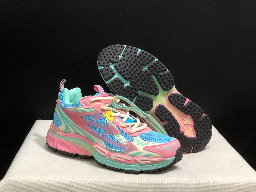Three-quarter view of the sneakers with one shoe lifted to show the black patterned outsole.