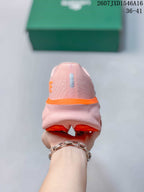 Rear view showing the pink heel, orange midsole accent, and orange outsole sections.