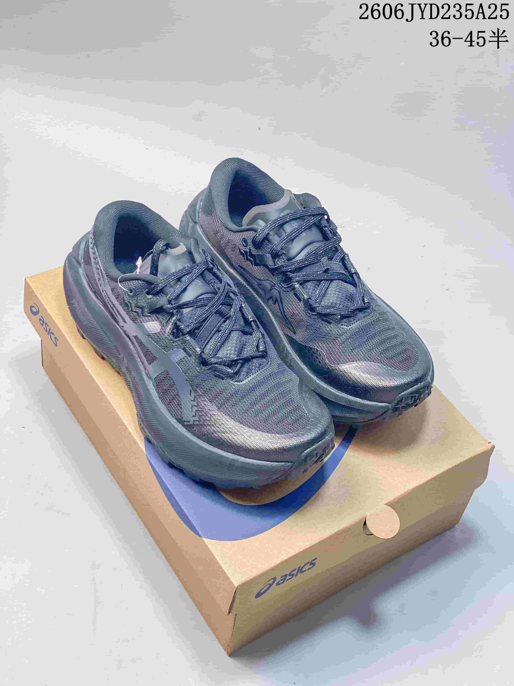 Dark gray ASICS GEL-TRABUCO MAX 5 shoes displayed on a shoe box