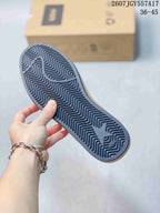 Close view of the sneaker outsole showing a dark patterned tread, star graphic, and raised branding details.