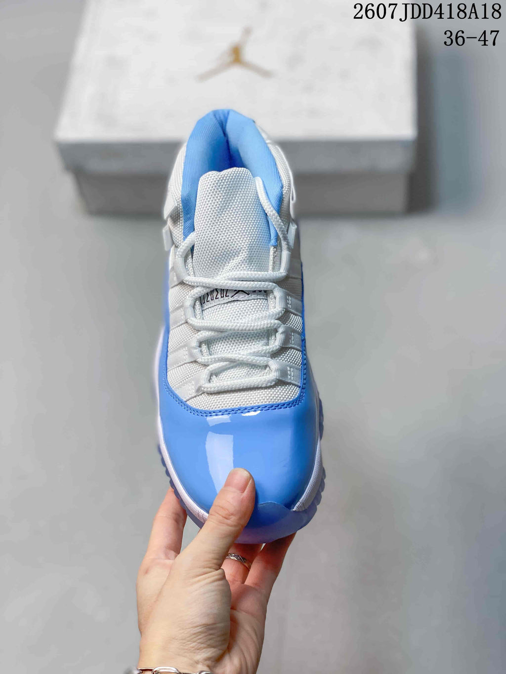 Top view showing the white laces, padded tongue, white upper and glossy blue toe area.