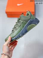 Side view of the olive green and navy Nike training shoe showing the mesh upper, layered lace supports and sculpted sole.