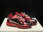 Angled front view of the pair showing the contrast red, black, and white upper design.