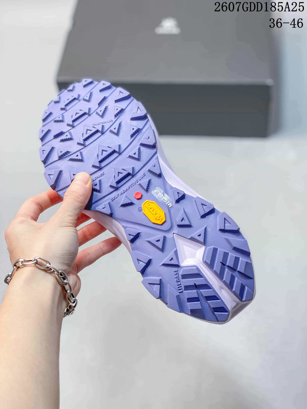 Underside view of the shoe showing a lilac lugged outsole with a visible Vibram mark and geometric tread pattern; overlay shows style code 2607GDD185A25 and size range 36–46.