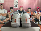 Rear view of white and red Nike basketball shoes showing perforated heels and red heel lettering.