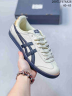 Close-up view of an off-white Onitsuka Tiger Tokuten sneaker with dark blue stripes and outsole.