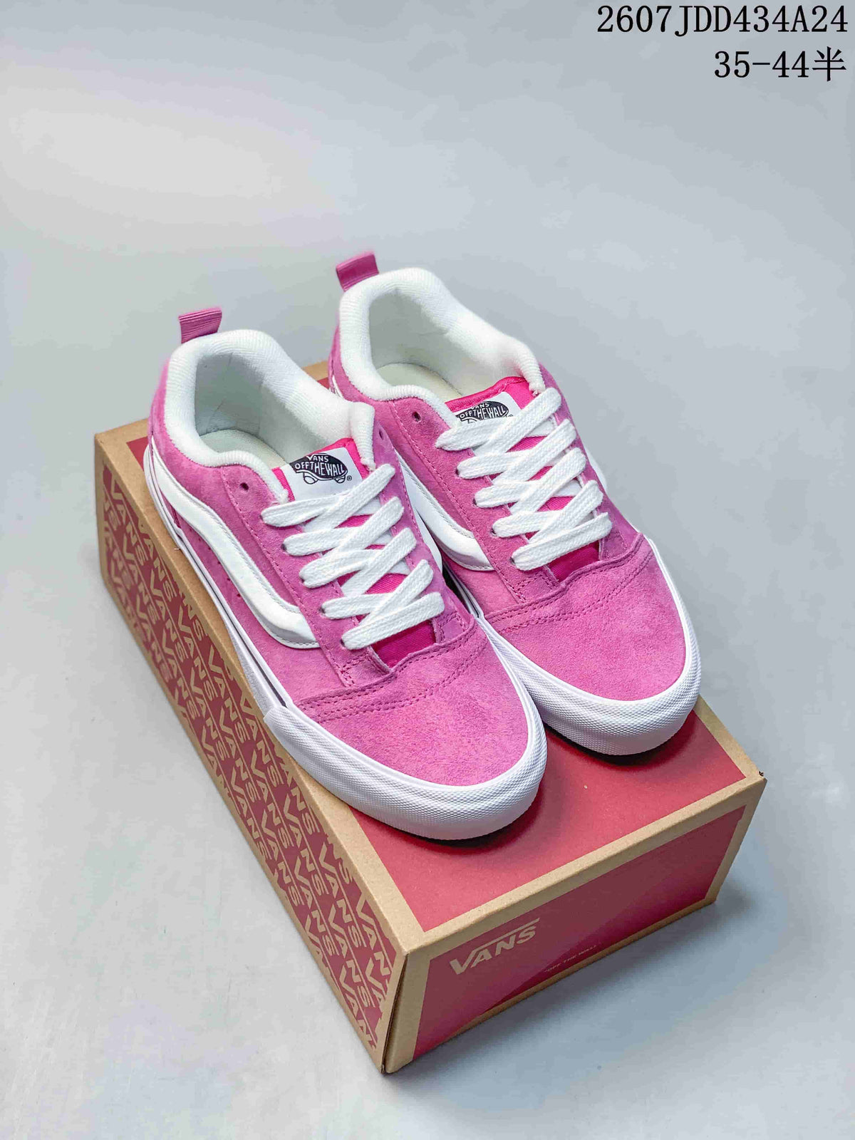 Pair of pink Vans Knu Skool sneakers displayed on a Vans shoe box, showing white laces, side stripes and padded collars.