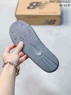 Close-up of the gray outsole showing raised circular tread details and textured sections.