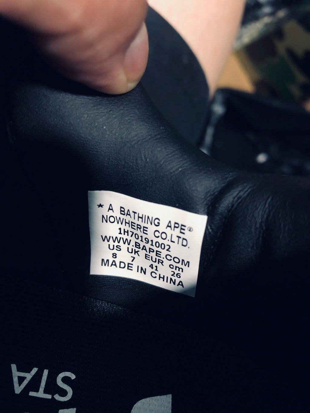 Close-up of the shoe label showing BAPE branding, US 8, UK 7, EU 41 and CM 26.