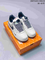 Pair of white and navy Nike Air Force 1 ’07 low-top sneakers displayed on an orange shoebox; size range text and style code are visible above.