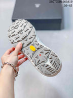 Close view of the outsole showing a directional lug pattern and yellow outsole branding.