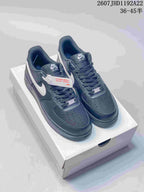 Pair of black and white Nike low-top sneakers displayed on a shoebox.