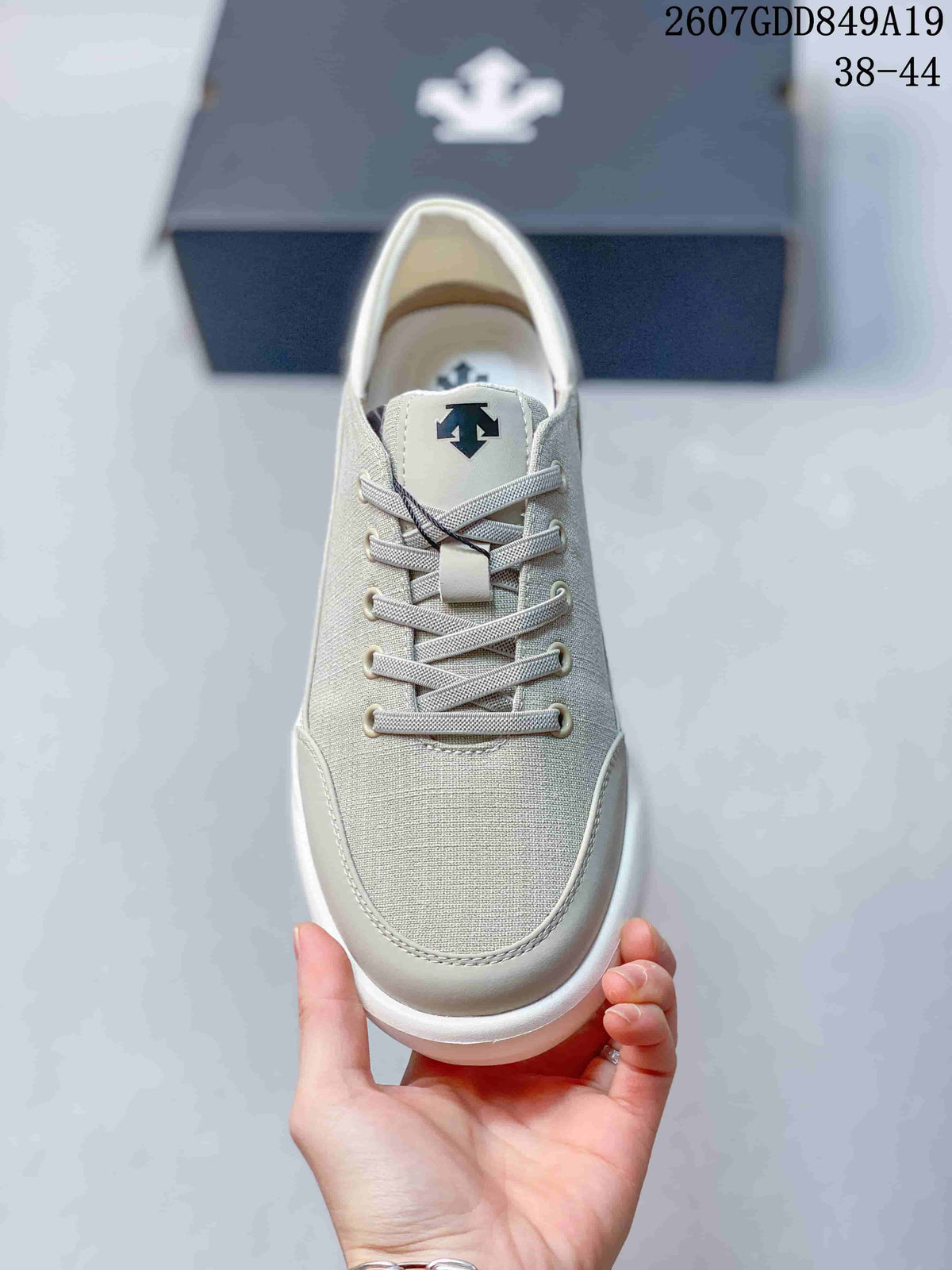 Top view showing the rounded toe, lace-up construction, eyelets, and Descente tongue logo.