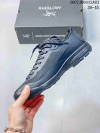 Side view of the low-cut gray lace-up shoe with textured panels