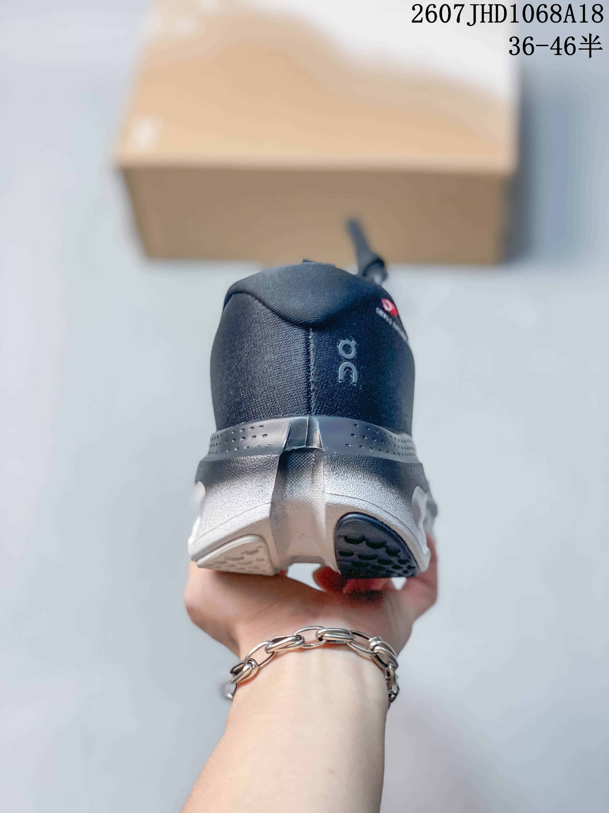Rear view of the sneaker showing the padded heel, On logo, and split-color outsole.