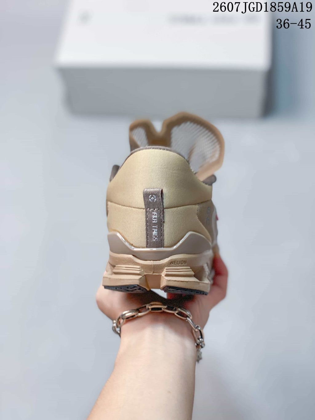 Rear view of the beige sneaker showing the padded collar, heel pull tab, and segmented outsole.