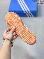 Close-up of the gum-colored outsole showing its textured tread pattern and circular traction details.