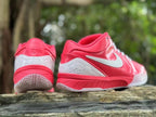 Rear and side views of pink Nike Kobe 4 shoes with translucent heel panels.