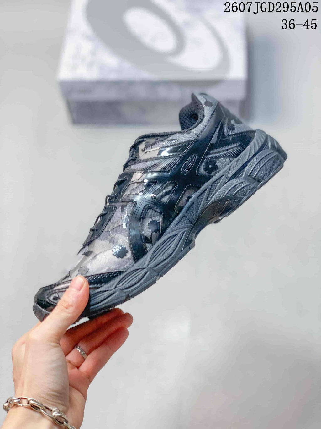 Side profile showing the floral upper, layered panels, lace closure, and segmented midsole.