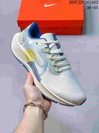 Close side view of a Nike Pegasus 38 shoe showing its perforated upper and colored overlays.