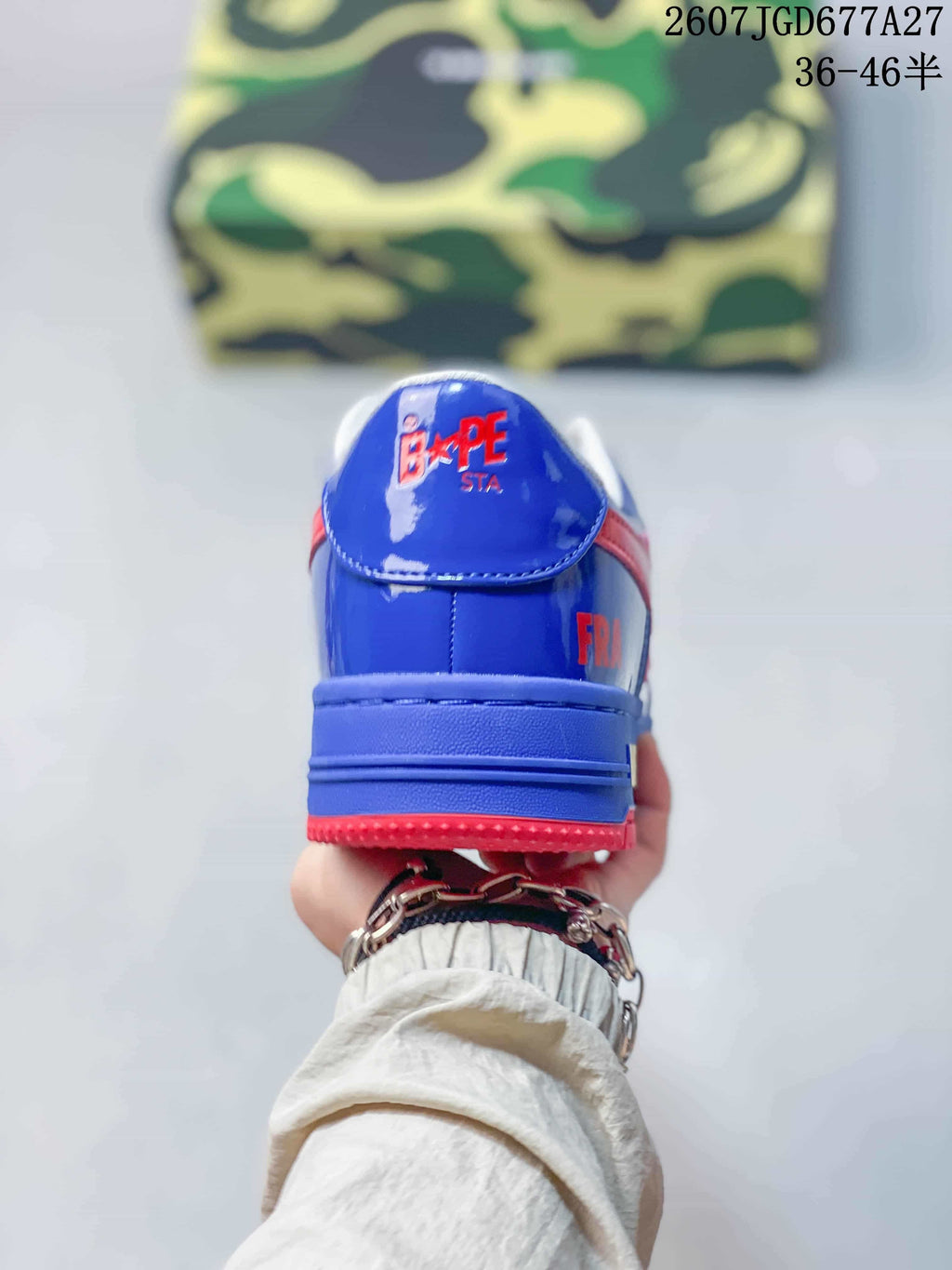 Rear view of a blue sneaker with a red outsole and BAPE STA branding on the heel.