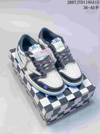 A pair of white, black and blue low-top sneakers displayed on a black-and-white checkered shoebox.