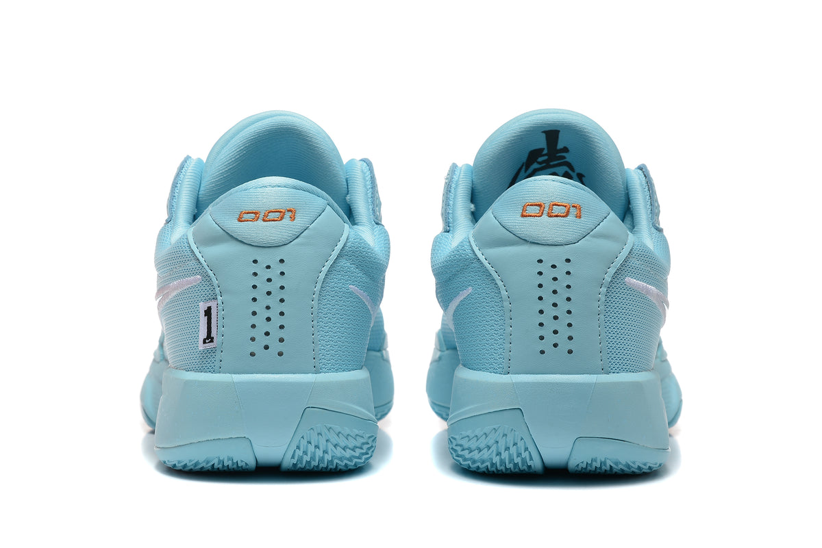 Rear view of the light-blue Nike G.T. Cut Academy shoes showing heel details and perforations