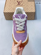 Front view of the purple sneaker with white laces and a chunky gum-colored toe-side outsole.