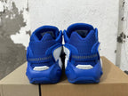 Rear view of blue and white Nike sneakers with mesh heels and heel straps