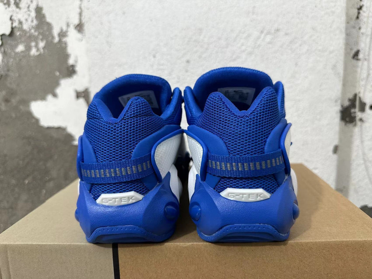 Rear view of blue and white Nike sneakers with mesh heels and heel straps