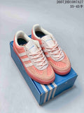 Pair of pink and white adidas Samba ADV sneakers displayed on a blue shoebox.
