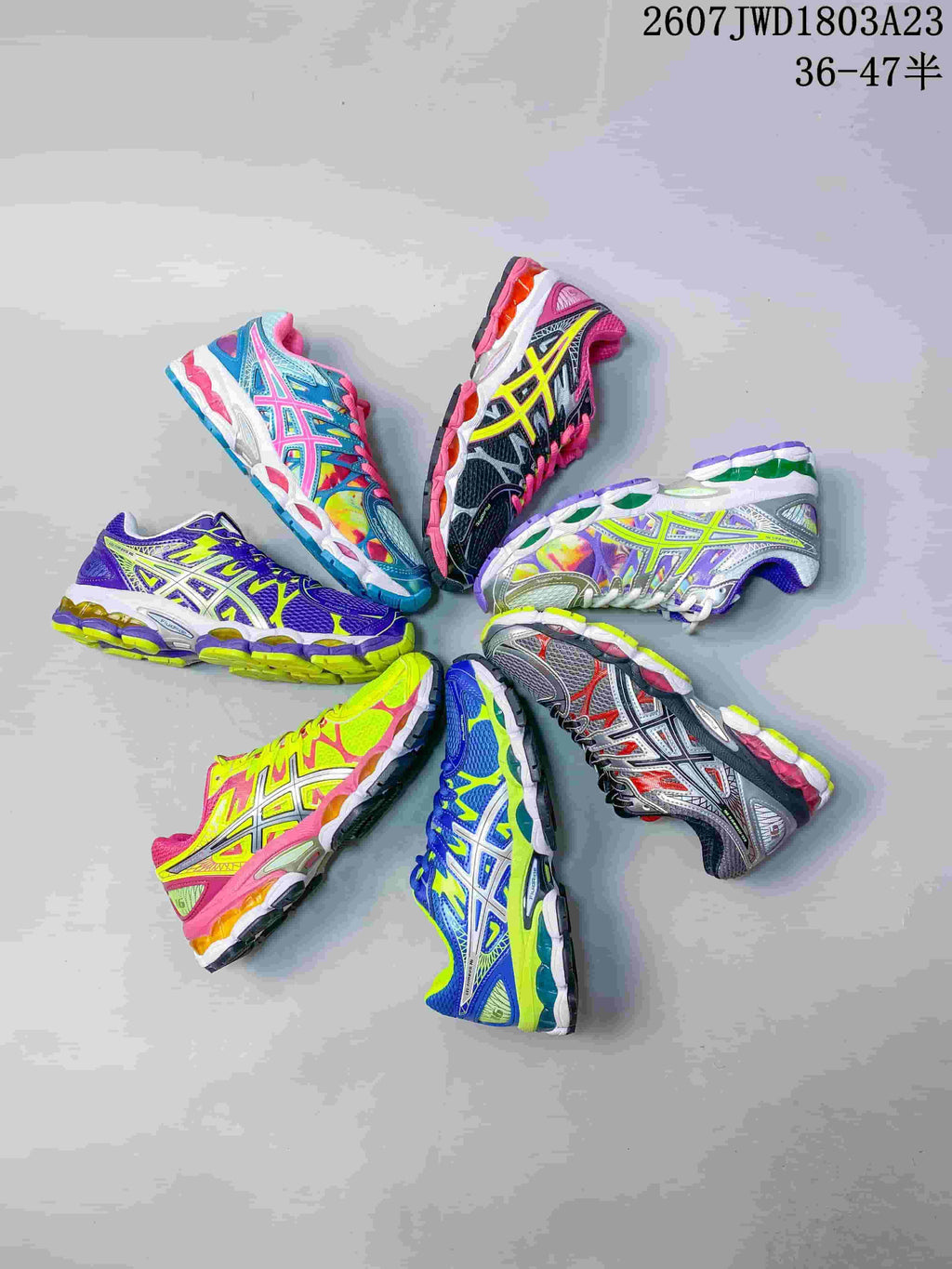 Seven colorful ASICS Gel-Nimbus 16 sneakers arranged in a circular display.