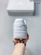 Rear view of a white Nike sneaker showing the Air branding on the heel and layered sole.
