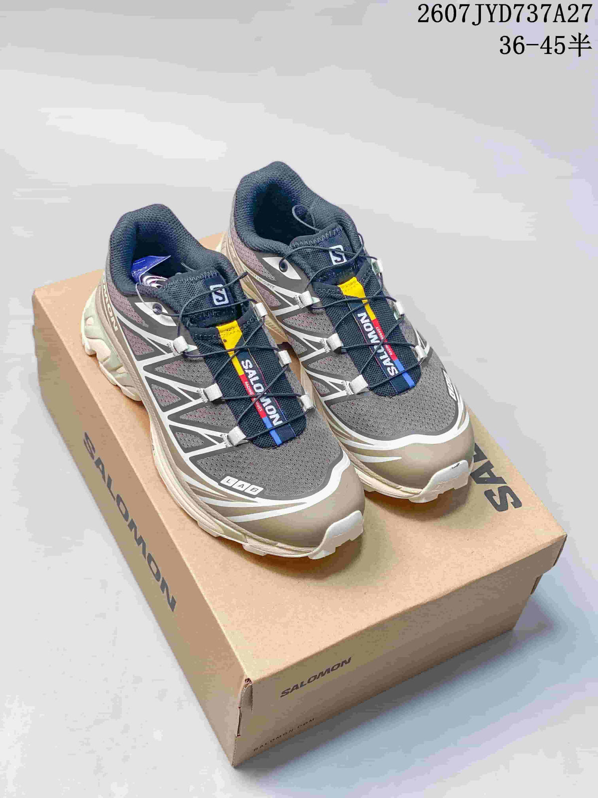 Pair of gray, taupe, navy, white, and yellow Salomon XT-6 sneakers displayed on a Salomon shoebox; overlaid text shows style reference 2607TYD737A27 and size range 36–45.5.