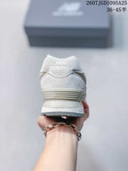 Rear view of the white and grey New Balance 574 sneaker showing the padded heel and layered sole.