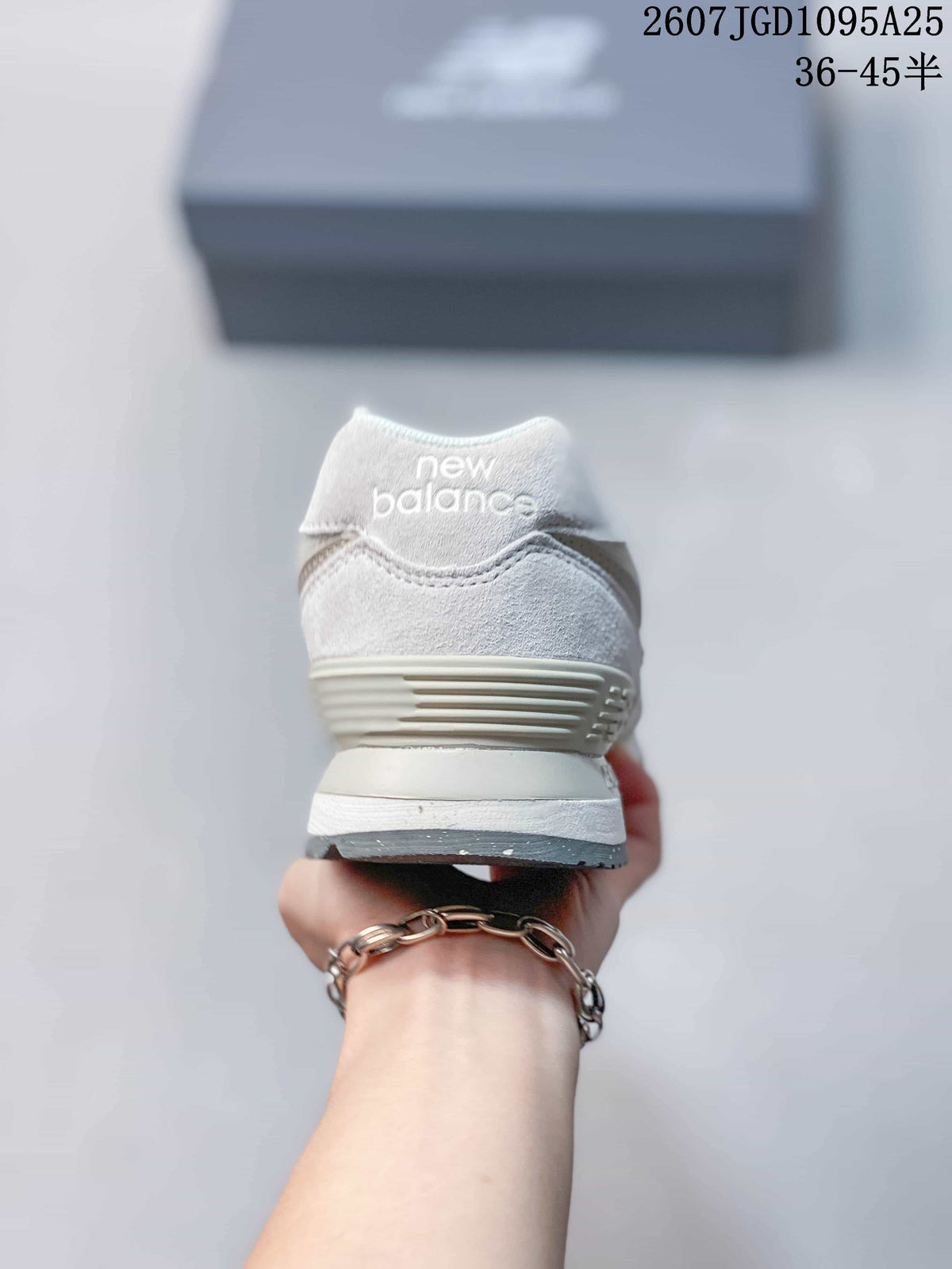 Rear view of the white and grey New Balance 574 sneaker showing the padded heel and layered sole.