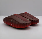 Pair of dark red slip-on sneakers shown from a three-quarter front angle.