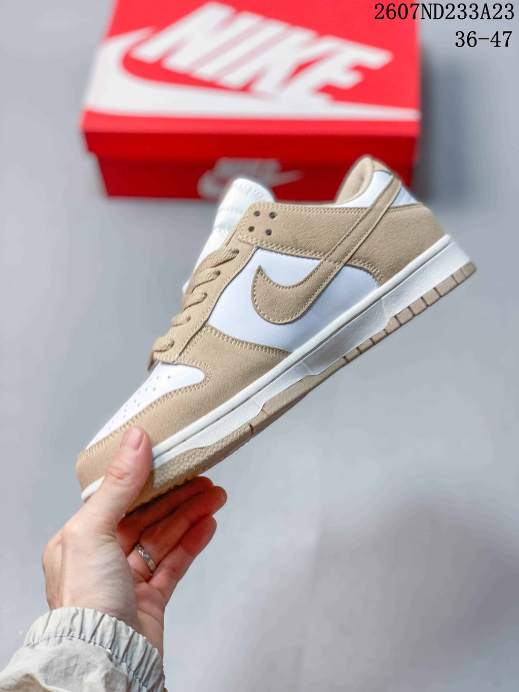 Side profile showing the beige Swoosh, white panels, beige overlays, and low-top silhouette.