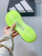 Close view of the textured neon yellow-green outsole with a central insert.